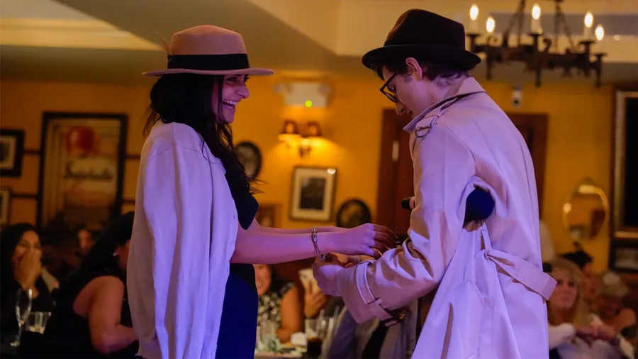 A Murder Mystery Company detective questioning a guest at a New Orleans show